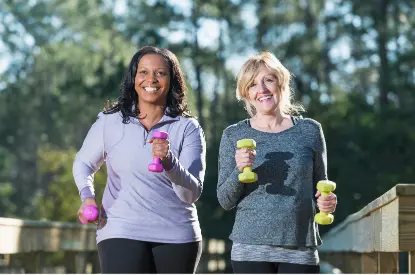 Two elderly woman in gym gear walking with weighs in their hands. This shows How to Look Good Without Makeup