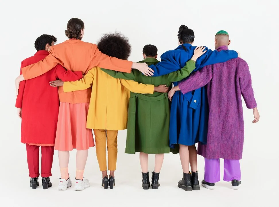 Six girls stand in a row showing off there colourful tops. Fashion and the Workplace: Grooming Standards | Image Consultancy